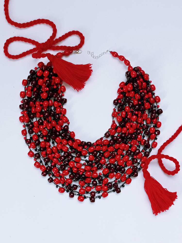 Glistening cherry red bead necklace on a black thread