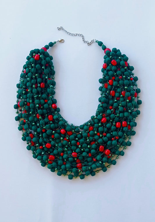 A matte bead necklace with occasional glossy beads resembles a barberry branch
